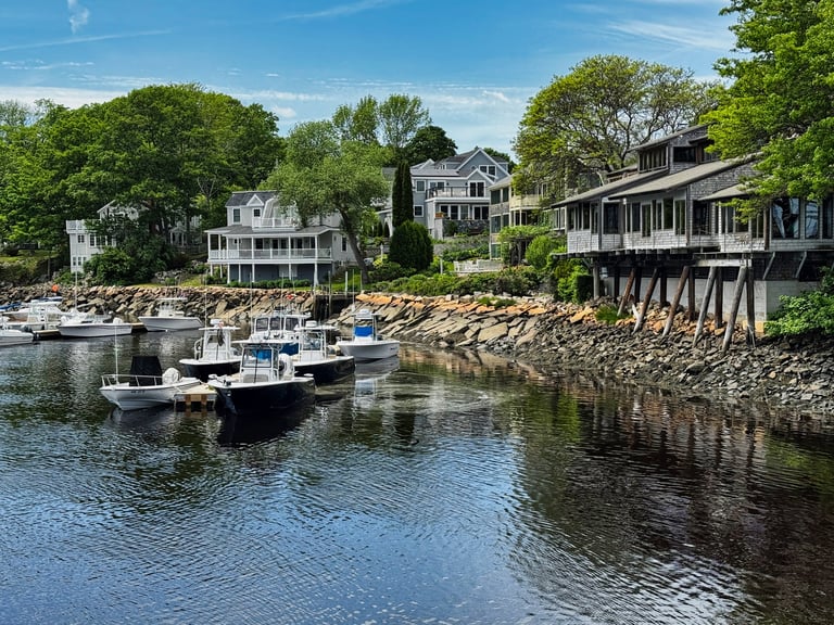 Perkins Cove small tidal harbor with lobster boats and fishing vessels, shops and restaurants along the coast